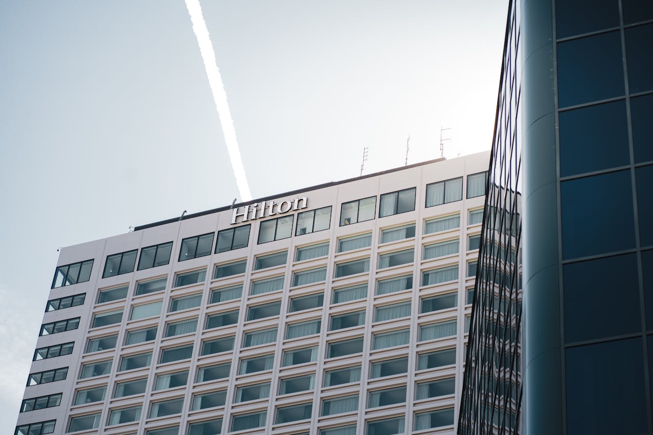 Modern Hilton Hotel building in Québec City captured from a low angle with clear blue skies.