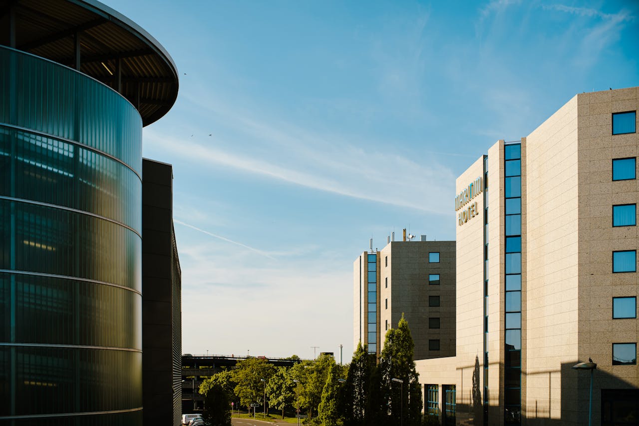 Contemporary hotel architecture with blue sky backdrop in city environment.
